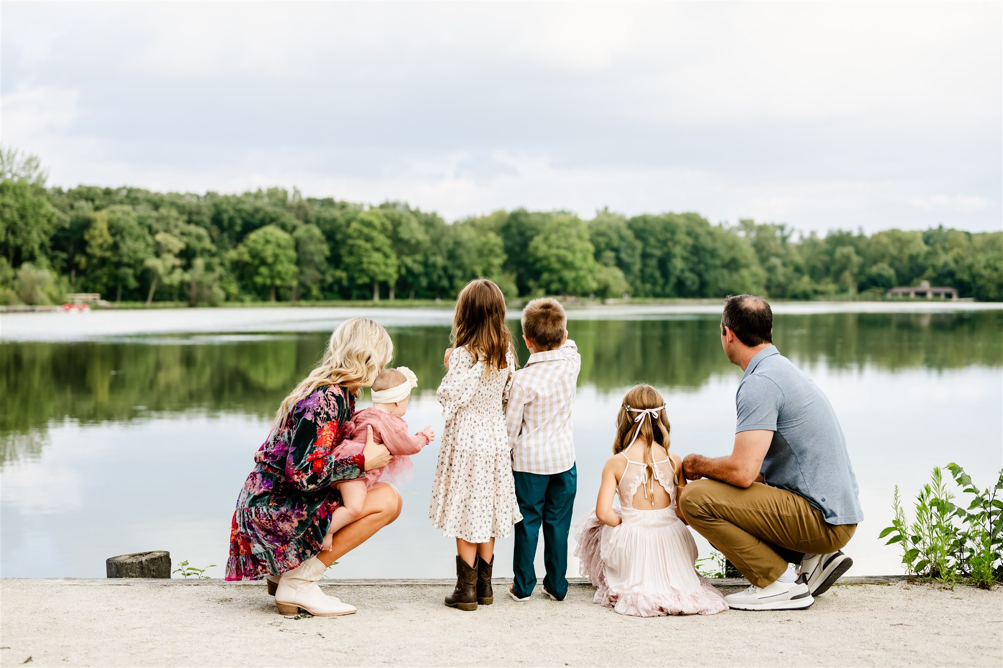 A happy family explores a park lake together